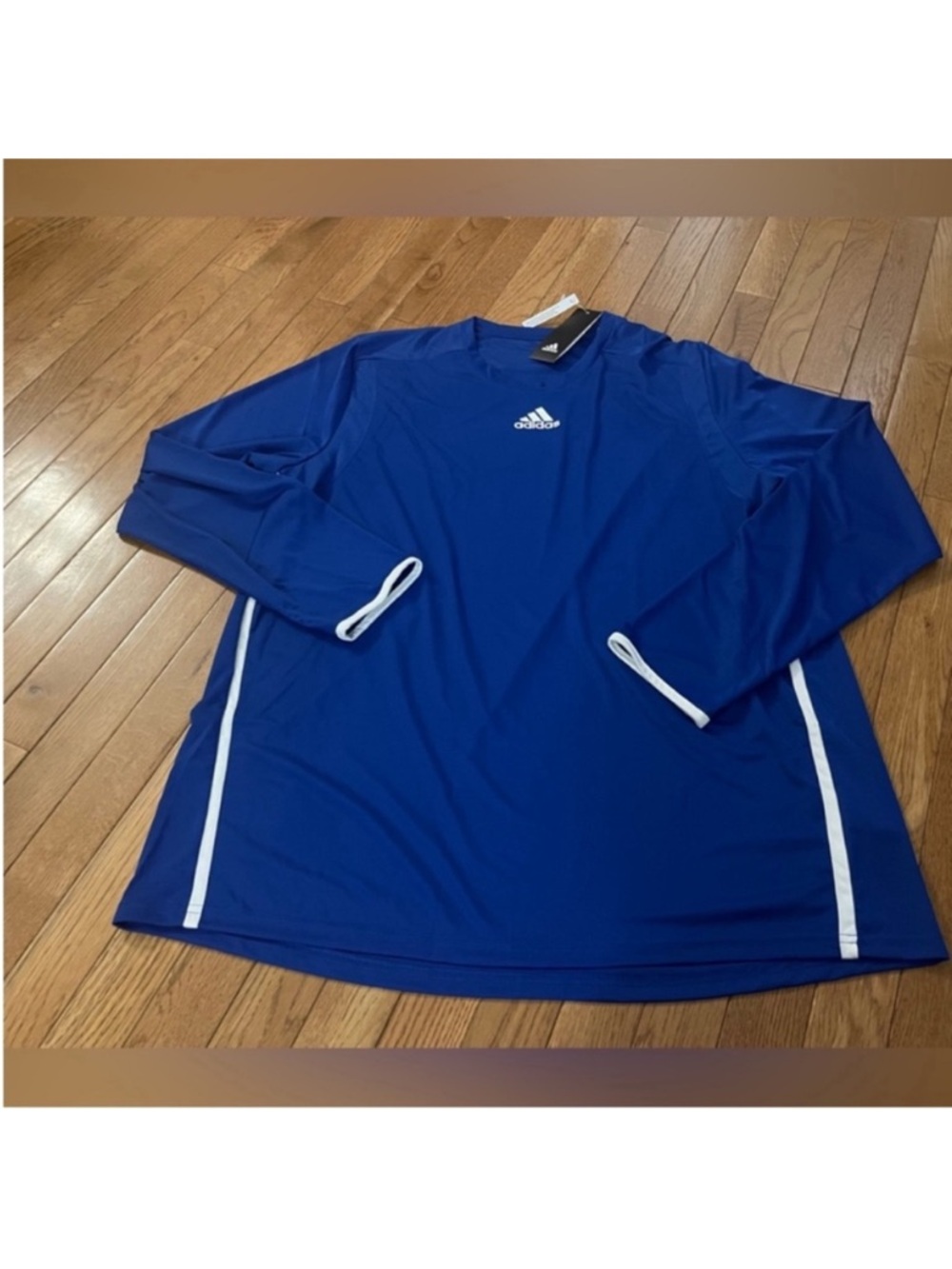 NWT royal blue top with white trim. Iconic Adidas logo on front.Men’s size XL